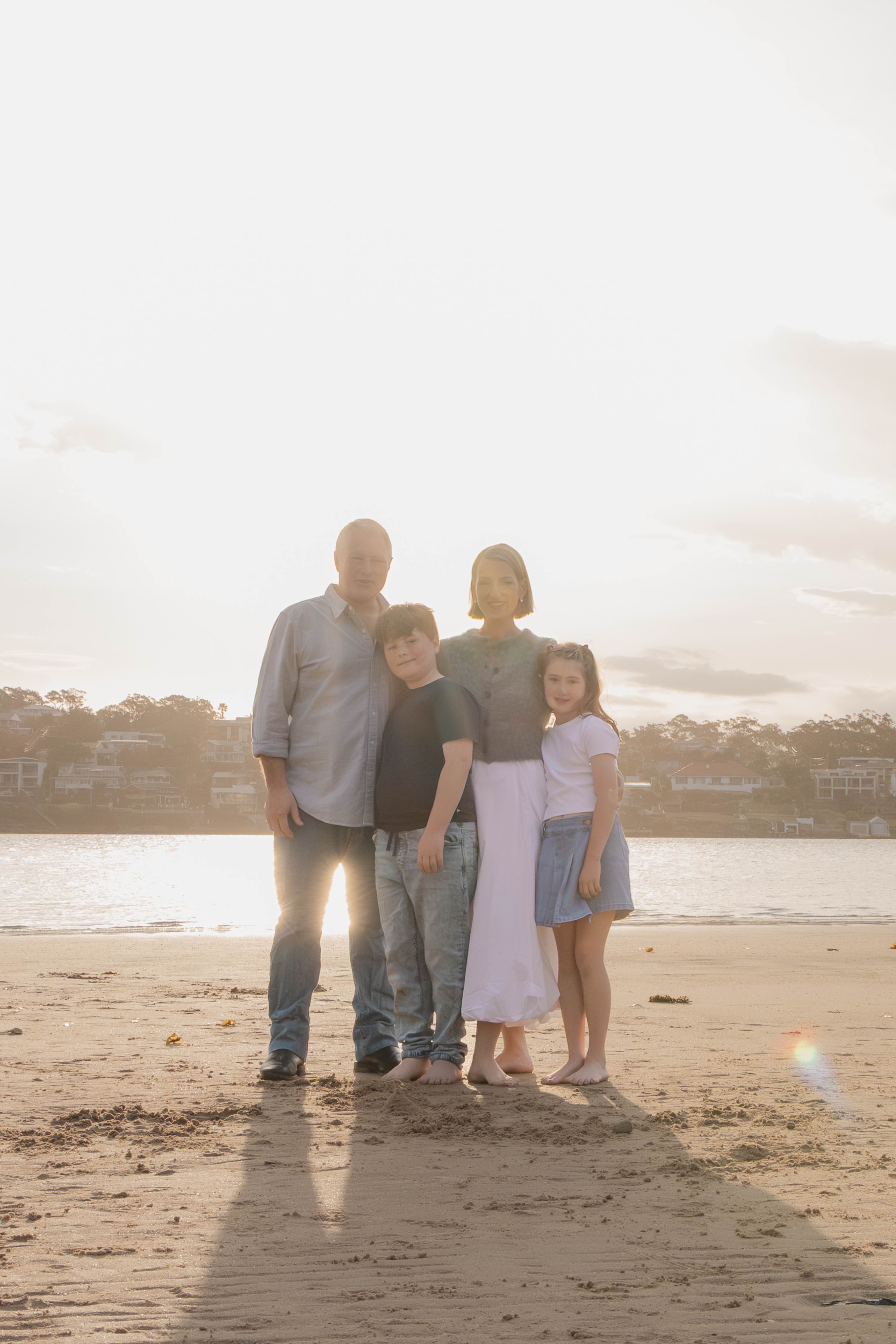 Dr Rebekah Hoffman with her family on the beach at golden hour